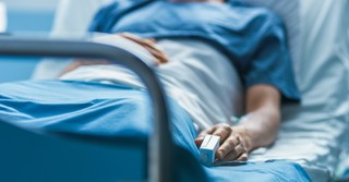 A man lying in a hospital bed