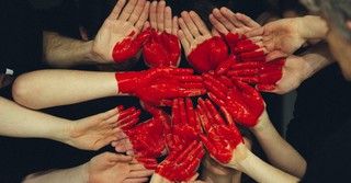 Painted hands forming a heart