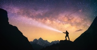 Man with a flashlight looking at the stars, i am the alpha and the omega