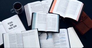 Bibles strewn across a table