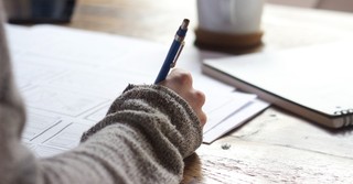 Woman journaling with a pen