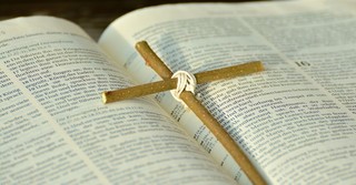 the Bible with a cross