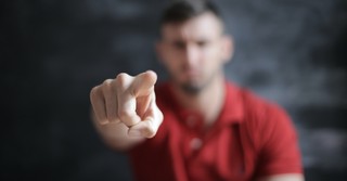 man pointing an accusing finger at camera