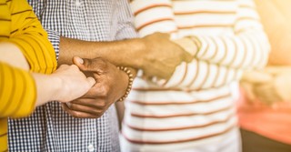 row of adults holding hands