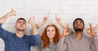 diverse adults looking and pointing up in hope that God answers prayer