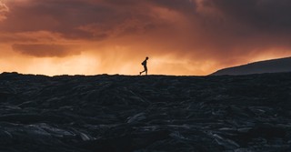 man walking against stormy cloudy sky