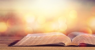 open bible at sunset