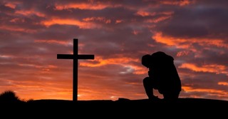 man kneeling by cross, trust in the lord for this is the day the lord has made