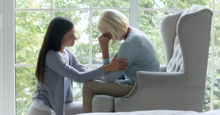 A young woman comforting an older woman