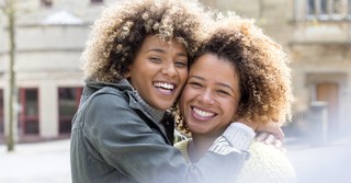 two sisters hugging