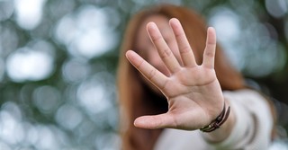 Woman holding her hand up in rejection