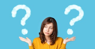 Woman considering two question marks