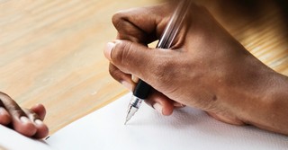 closeup of a person's hand writing