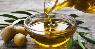 Olive oil poured into a small glass dish