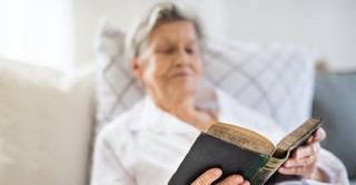 Woman reading the Bible in bed