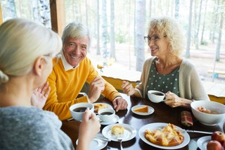Adults enjoying a meal together