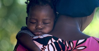 Baby asleep on mother's shoulder