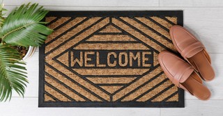 A welcome mat outside of a front door