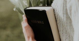 Closeup of a woman holding a Bible