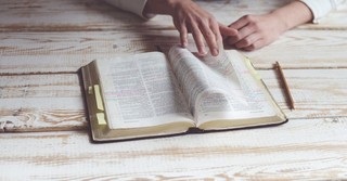 Woman turning the pages of the Bible