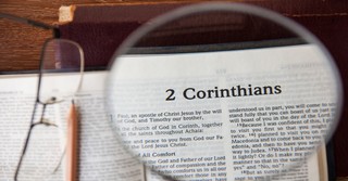 Magnifying glass over first page of 2 corinthians