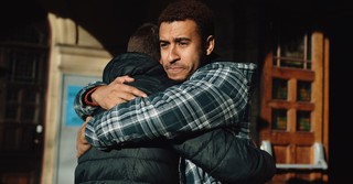 sad man hugging another man as friends