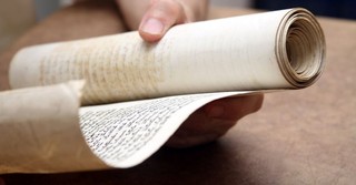 A person reading an ancient scroll