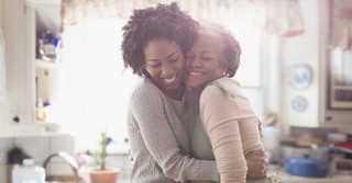 older mother and daughter hugging