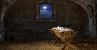 Manger in a stable, with the star of Bethlehem visible out a window