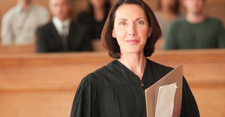 A female judge looking at the camera