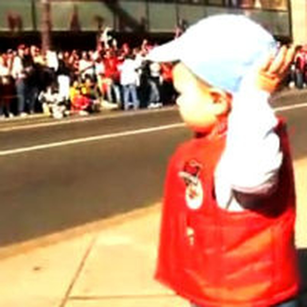 Watch One Cute Toddler Lead a Crowd of People in Cheers