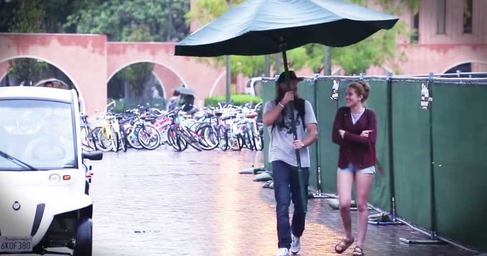 Kind Man Helps Strangers In the Rain With Giant Umbrella