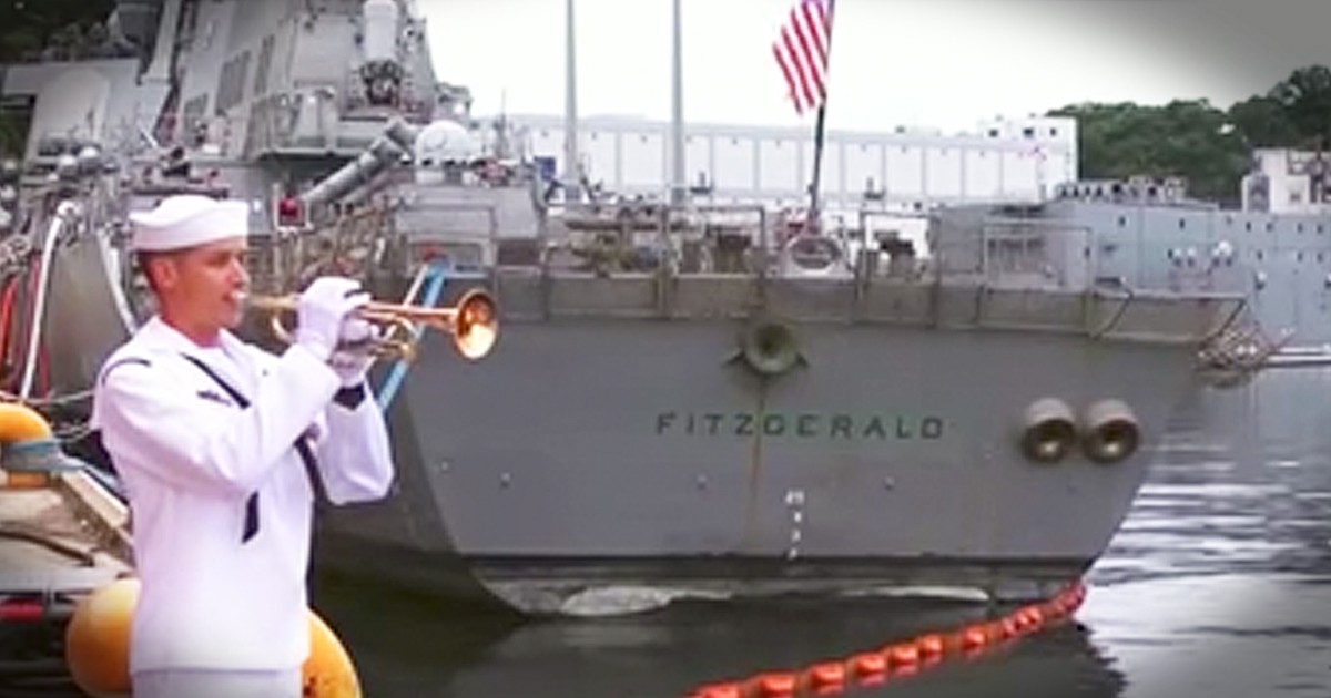 Navy Sailor Stands Alone On Dock And Plays Taps For Fallen Shipmates