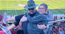 Girl Struggled with Stairs at Football Game and Image of Police Officer Carrying Her Went Viral