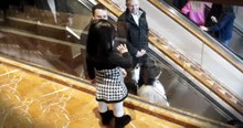 Little Girl Says Bye To People On Mall Escalator