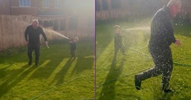 Toddler ‘Watering’ Grandad With the Hose