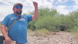 Street Preacher By The River Calling Out Sin And Pointing To Christ