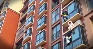 Firefighter Dramatically Rescues Suicidal Woman From The Side Of A Building