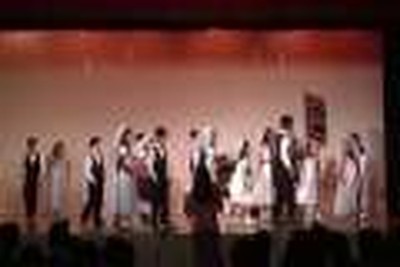 Children do a song and dance number