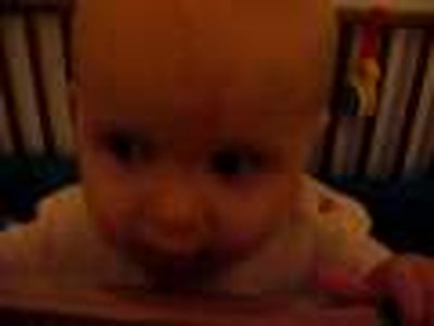 Beenie stands in crib