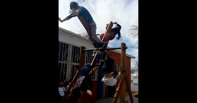 Children Learn How To Master Teamwork On A Playground Contraption