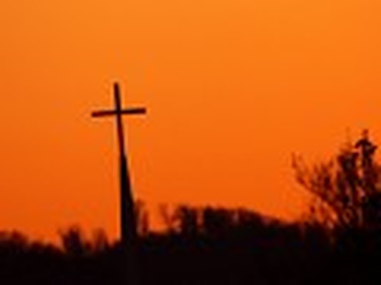 Cross in the Distance with an Orange Sky