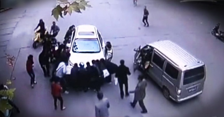 Woman Trapped Under Car Is Saved By A Group Of Strangers