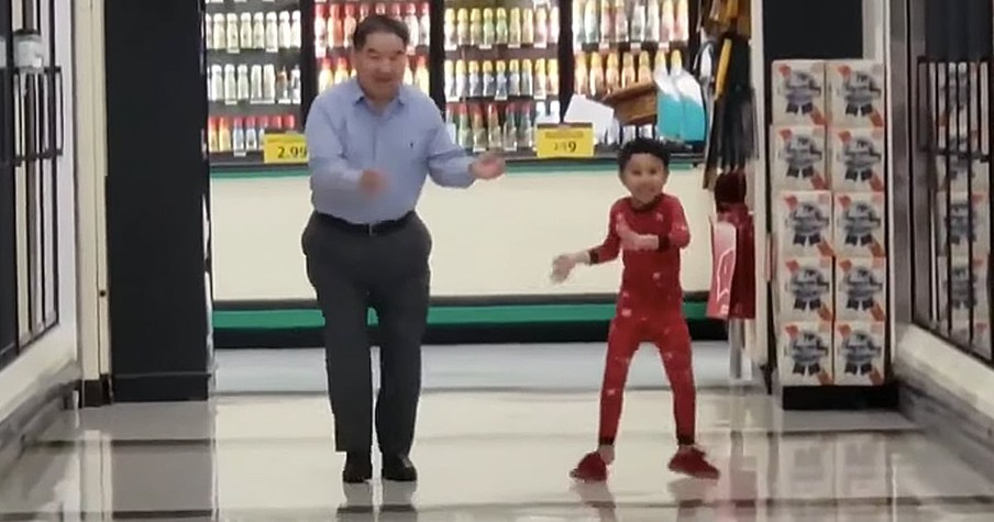 Young Boy Dances In The Supermarket Aisle With His Grandpa Before Surgery