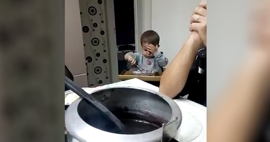 Little Boy Sneaks A Bite Of Food During Prayer Time