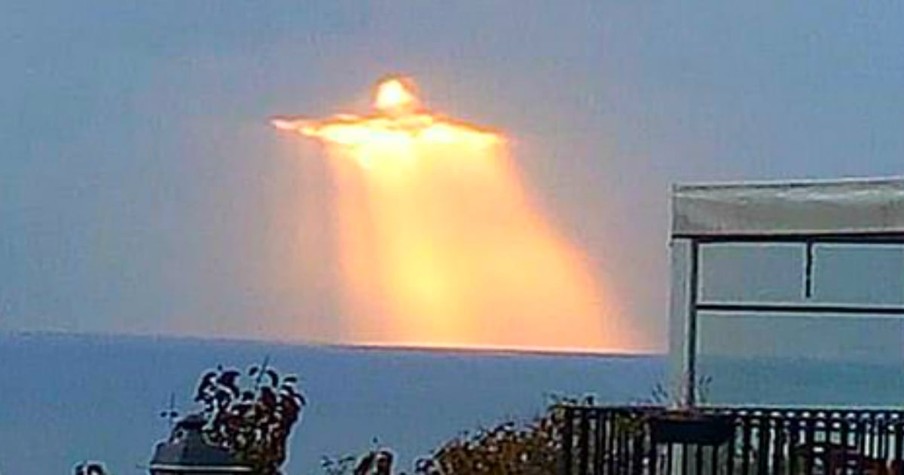 Man's Incredible Photos Of Mysterious Figure Glowing In The Clouds Go Viral