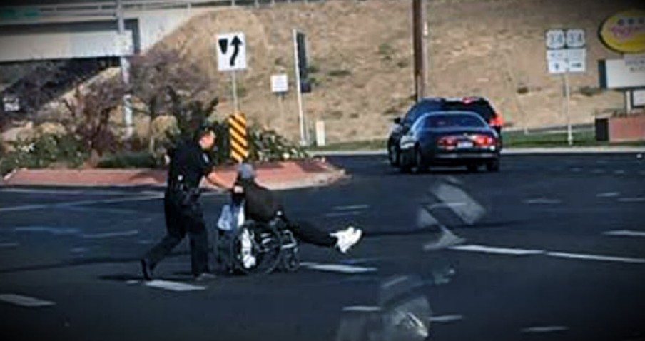 Officer Parks At Busy Intersection To Help A Man In A Wheelchair Cross