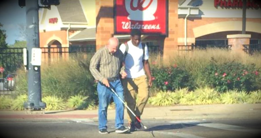 Teen Helps A Blind Man Cross A Busy Intersection