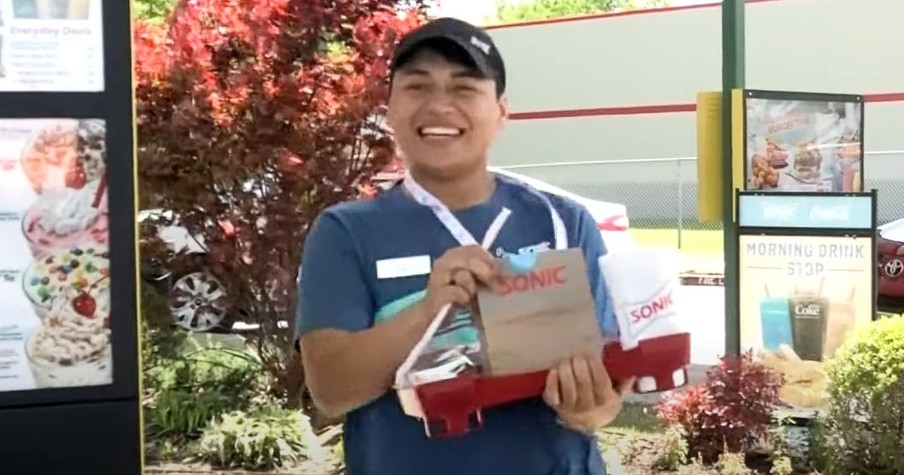 Stranger Hands Joyful Young Man Working For Sonic Fast Food Restaurant A Huge Tip