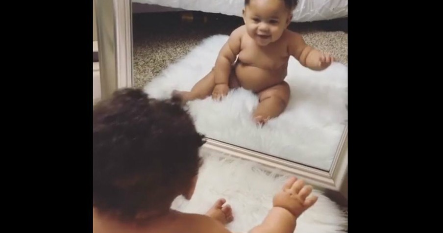 Baby Girl Has A Good Time Seeing Her Reflection While Looking In A Mirror